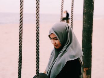 Woman wearing hijab at beach