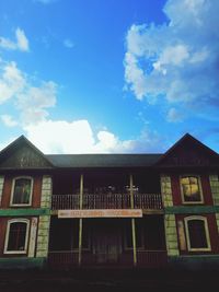 Low angle view of building against cloudy sky