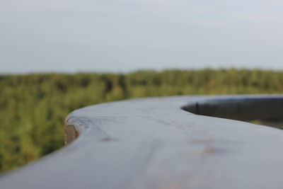 Close-up of road on field against sky