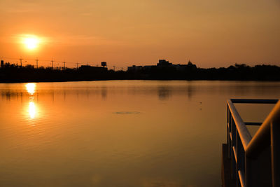 Scenic view of lake against orange sky