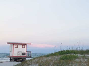 Lifeguard hut on beach against sky