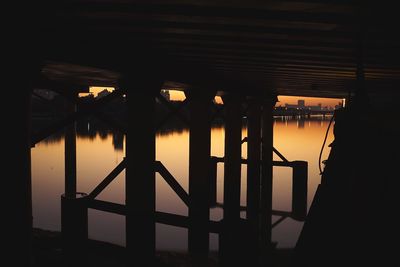 Silhouette built structure against sky during sunset