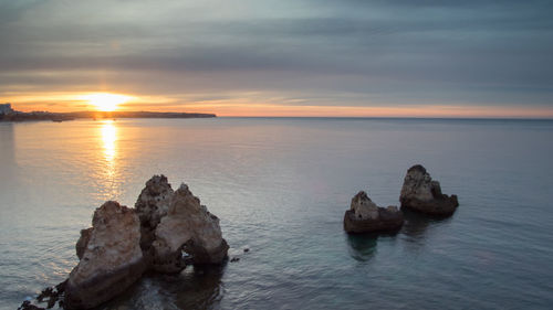 View of boats in calm sea at sunset