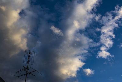 Low angle view of communications tower against blue sky