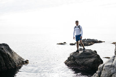 Man looking at sea against sky