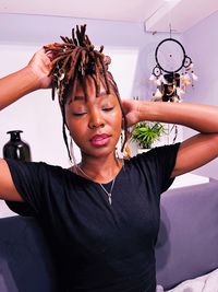 Portrait of young woman sitting on sofa at home