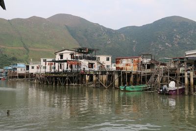 Scenic view of buildings and mountains against sky