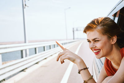 Side view of young woman using mobile phone