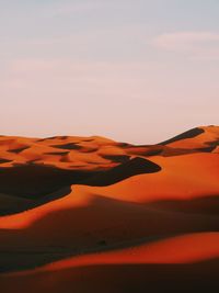 Scenic view of desert against sky during sunset
