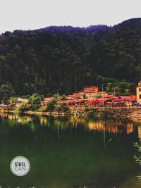 Reflection of trees and buildings in lake