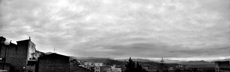 Houses against cloudy sky