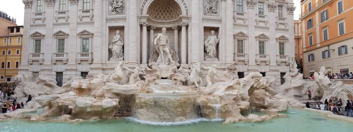 View of fountain in front of historical building