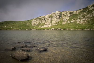 Scenic view of lake and mountains against sky