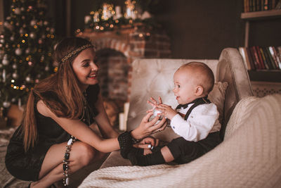 Mother and son playing on sofa at home