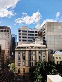 Residential buildings in city against sky