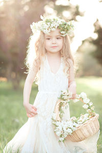 Cute girl wearing wreath at park