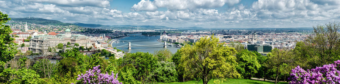 Panoramic view of chain bridge against cloudy sky