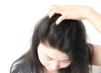 Close-up of young woman over white background