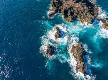 High angle view of rock formation in sea