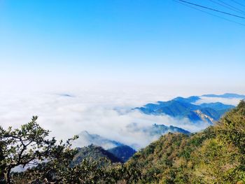 Scenic view of mountains against blue sky