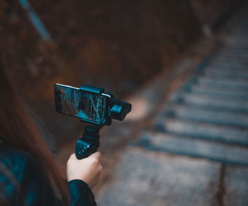 Close-up of woman photographing with mobile phone