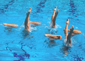 Low section of young woman swimming in pool