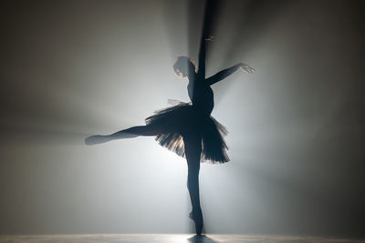 Silhouette ballet dancer dancing on stage