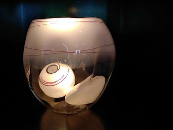 Close-up of illuminated lamp on table