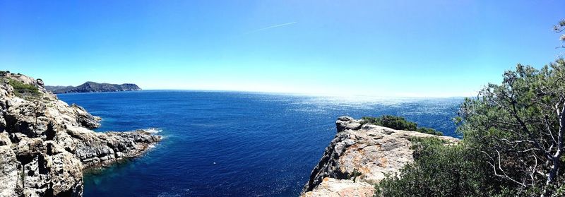 Scenic view of sea against clear blue sky