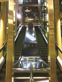 Low angle view of illuminated escalator at subway station