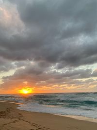 Scenic view of beach against sky during sunset