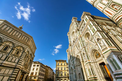 Low angle view of buildings against blue sky