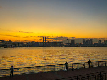 Bridge over river at sunset