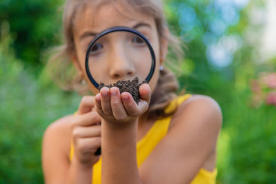 Midsection of woman holding plant