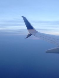 Airplane wing against sky