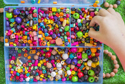 High angle view of person holding multi colored candies