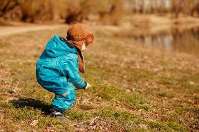 Side view of boy on field