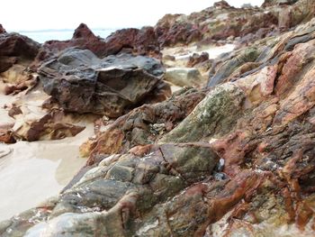 Rocks on beach against sky