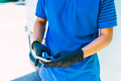 Working with the mobile with black latex gloves in the center of madri