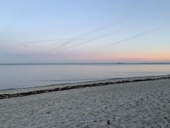 Scenic view of beach against sky during sunset