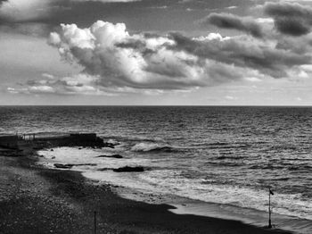 Scenic view of sea against cloudy sky