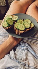 Midsection of woman holding breakfast in plate