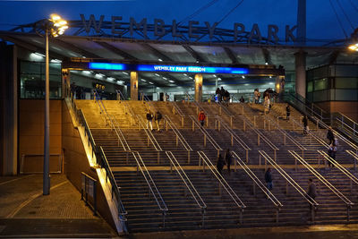 People at railroad station at night