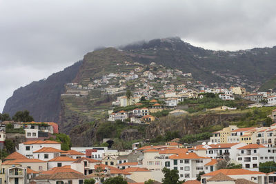 Buildings in town against sky