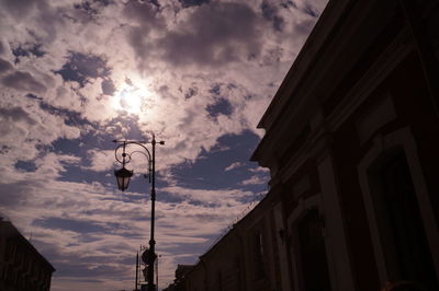 Low angle view of building against cloudy sky