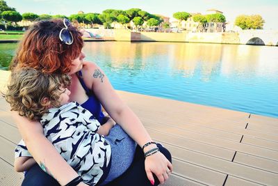 Woman sitting in swimming pool