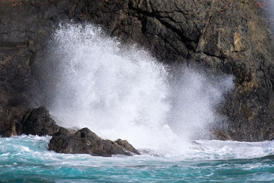 Sea waves splashing on rocks