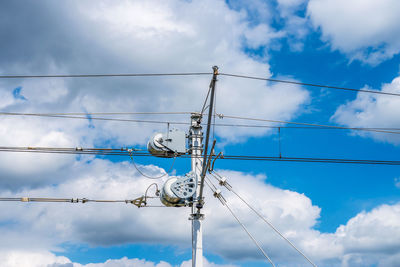 Low angle view of electricity pylon against sky. railway infrastructure