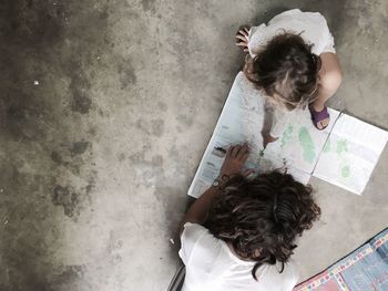 High angle view of woman holding paper