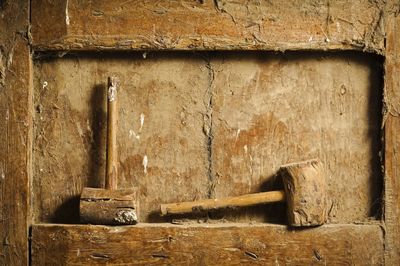 Close-up of mallets on dirty wooden niche